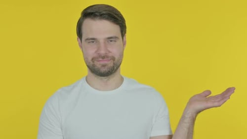 Young Adult Presenting on Yellow Background