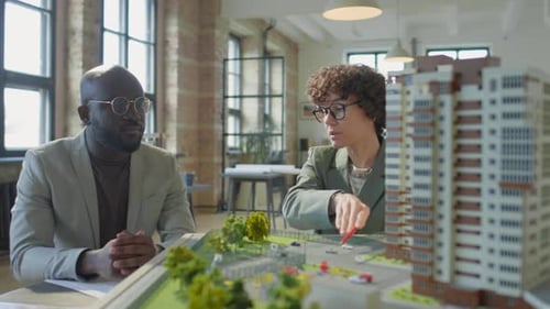 Female Architect Presenting Real Estate Project to Investor