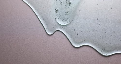 Translucent Blue Liquid Spreading on a Metallic Surface