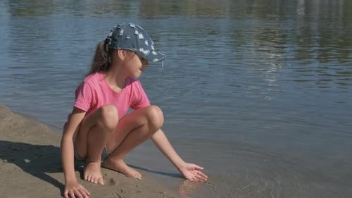 A child plays by the river.
