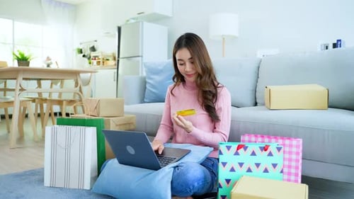 Woman Shopping Online with Laptop at Home