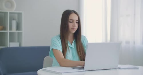 Woman Using Laptop at Home During the Day