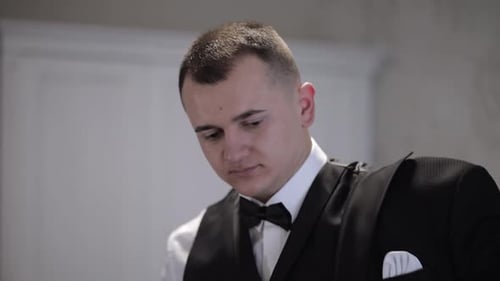 Man Getting Ready Wearing a Tuxedo Indoors