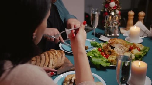 Close Up of Couple Enjoying Festive Dinner with Meal and Alcohol