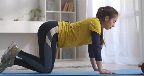 Woman Doing Donkey Kicks at Home