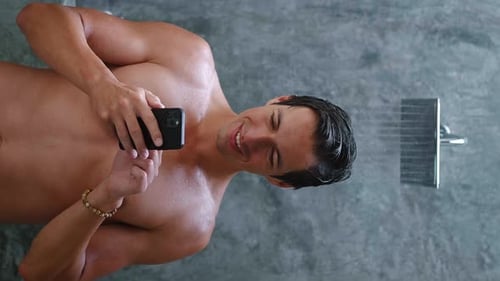Man Taking Shower While Holding Smart Phone