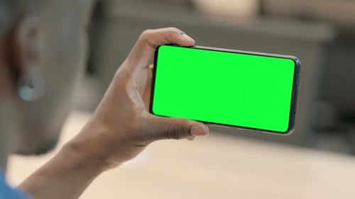 Man Holding Phone with Green Screen in Horizontal