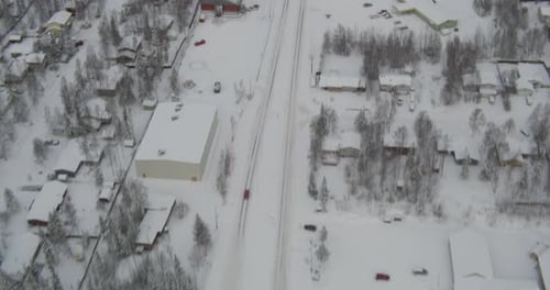 Aerial View of Road and Snowy Suburban Landscape