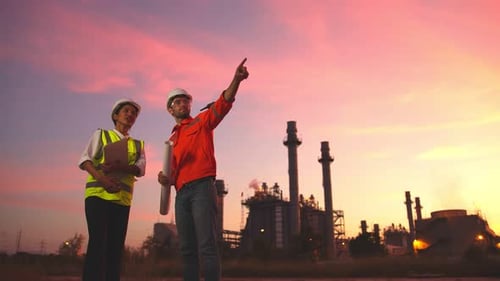 Engineers at Power Plant at Sunset