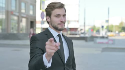 Handsome Young Adult Man Invites with a Gesture