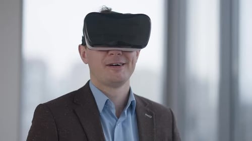 Man Experiencing Virtual Reality Headset in Modern Office