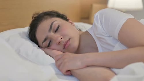 Young Indian Woman Sleeping in Bed Peacefully