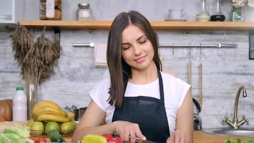 Woman Preparing Fresh Vegetable Salad in Kitchen