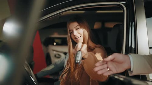 Car Dealer Giving Key to New Car Owner
