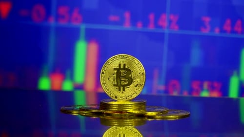 Shiny Gold Bitcoin on Pile of Coins