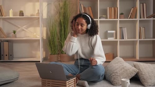 Woman Listening to Music with Headphones at Home
