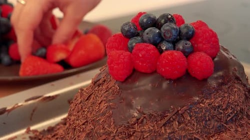 Berry Topped Chocolate Cake being Decorated