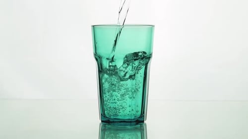 Сrystal Clear Water Pouring Into Green Faceted Glass