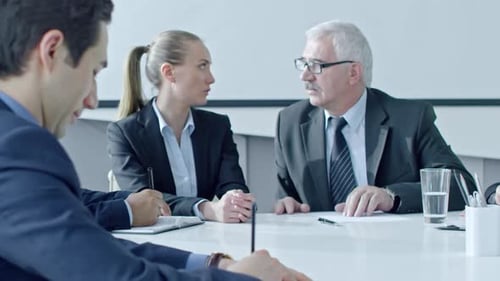 Office Worker Signing Document at Meeting