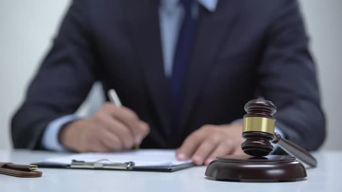 Adult Writes and Picks Up Gavel in Office