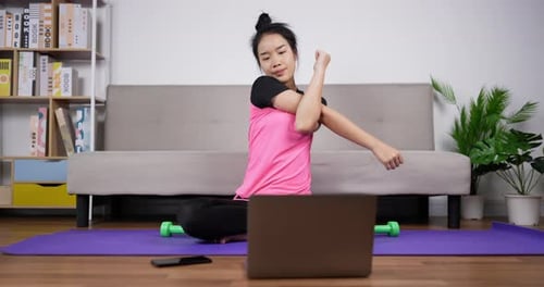 Woman Doing Arm Stretches at Home