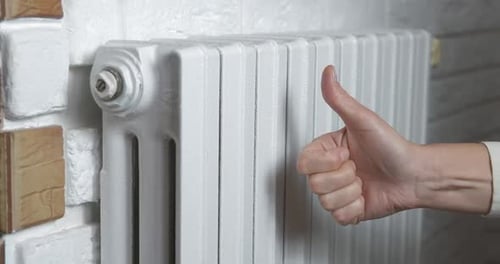 Hands from a heating radiator.