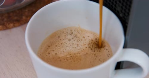 Fresh Coffee Pours Into White Mug