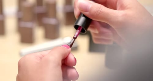 Woman Applying Pink Nail Polish, Close Up