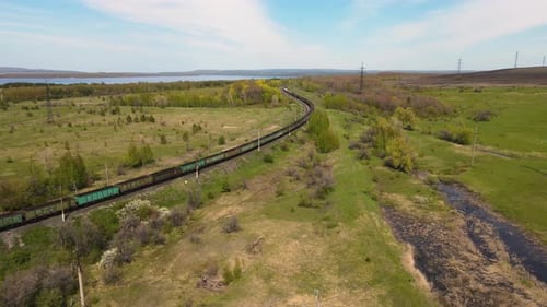 Aerial view of a freight train traveling through the countryside