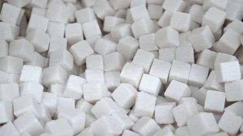 White Sugar Cubes Close Up Panorama on a Background of Refined for Your Text.