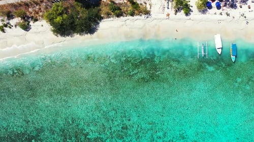Wide angle overhead island view of a sandy white paradise beach and blue ocean background in colourf