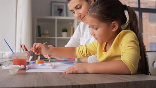 Mother and Child Painting Together Indoors