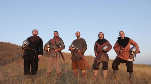 Group of People Dressed in Chainmail with Swords
