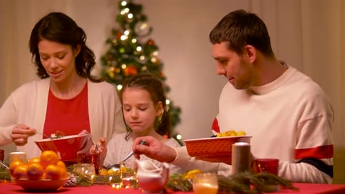 Family Enjoying Christmas Meal Together at Home