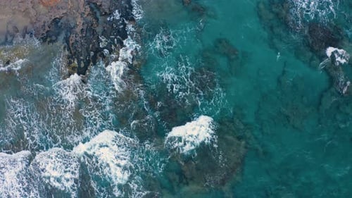 Aerial view of natural background - Foaming and Splashing in the Ocean. Fly above sea water