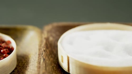Red Peppercorns and White Spice in Wooden Bowls