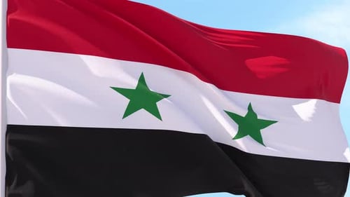 Waving Syrian Flag Against Blue Sky
