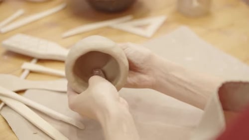 Hands Shaping Pottery Bowl in Art Studio