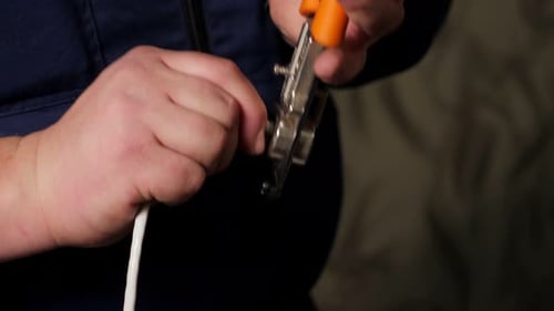 Hands Cutting Cable With Wire Cutters
