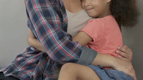 Mother and Child Embracing on Sofa
