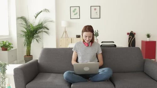 Auburn-haired Woman Working on Laptop at Home