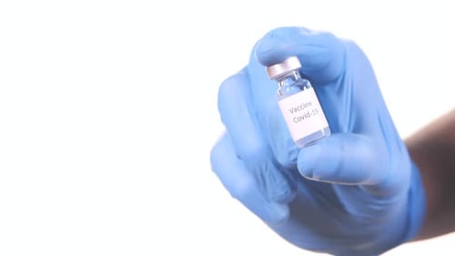 Gloved Hand Holding Vaccine for Covid-19
