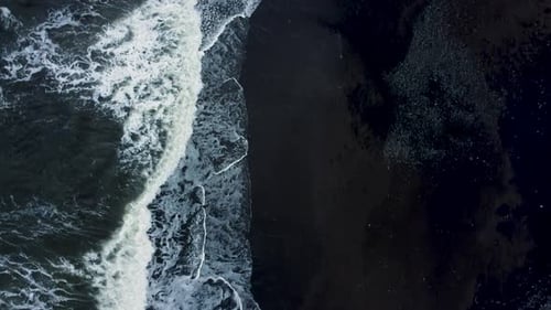 Top down vies waves on the black sand beach