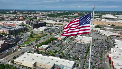 American Flag Waving Over an Expansive Cityscape