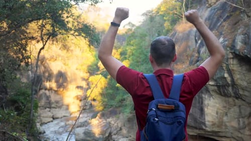 Happy Traveler with Backpack Celebrating Reach Mountain Top