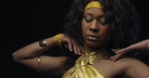 Glamorous Woman with Golden Jewelry Poses