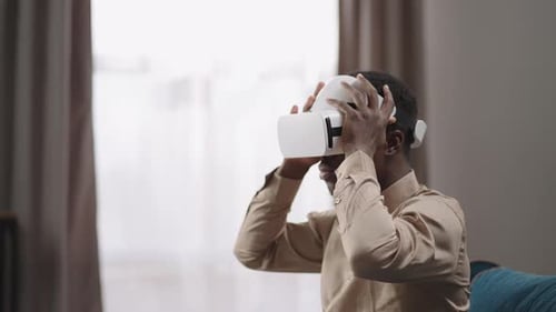 Man Takes Off VR Headset in Living Room