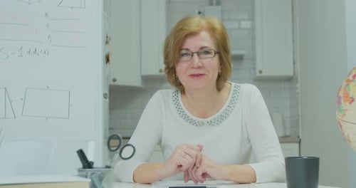 Teacher Explains Math Lesson at Table