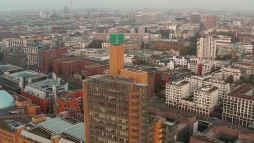 AERIAL: View of Berlin Germany Atrium Tower Potsdamer Platz Skyscraper Cityscape in Beautiful Orange
