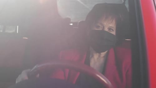 Senior Woman Wearing a Mask Driving Car